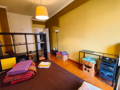 a living room with a bed and a desk at Studio in Athens center in Athens