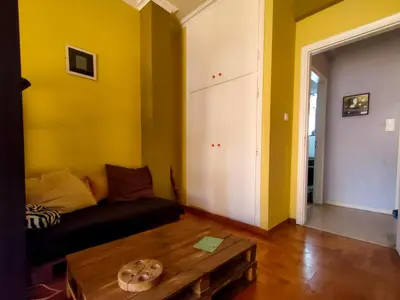 a living room with a couch and a table at Studio in Athens center in Athens