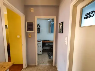 a hallway with a yellow door and a desk at Studio in Athens center in Athens
