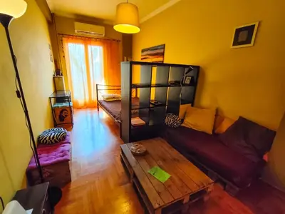 a living room with a couch and a table at Studio in Athens center in Athens