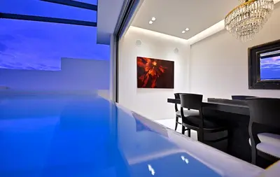 a dining room with a table and a painting at ALTO PSYRRI PENTHOUSE by K&K in Athens