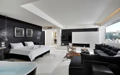 a bedroom with a bed and a flat screen tv at ALTO PSYRRI PENTHOUSE by K&K in Athens