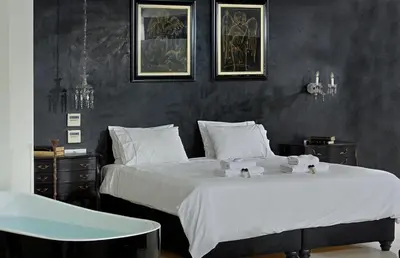 a bedroom with two beds with white sheets and a table at ALTO PSYRRI PENTHOUSE by K&K in Athens