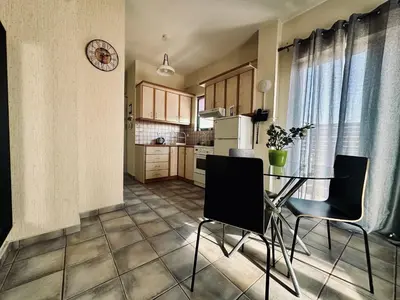 a kitchen with a table and chairs in a room at Cozy Apartments Mc Queen in Athens