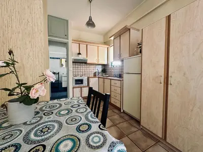 a small kitchen with a table with a flower on it at Cozy Apartments Mc Queen in Athens
