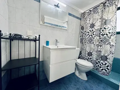 a bathroom with a toilet and a sink and a shower at Cozy Apartments Mc Queen in Athens