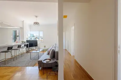 a living room and kitchen with a couch and a table at 3 bdr Apt Incredible Acropolis View in Athens