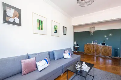 a living room with a blue couch with pillows on it at 3 bdr Apt Incredible Acropolis View in Athens