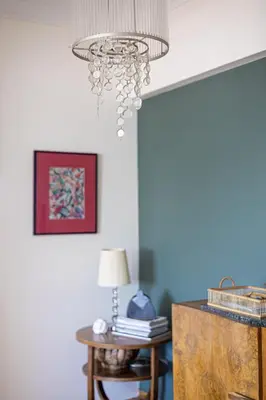 a chandelier in a living room with a table at 3 bdr Apt Incredible Acropolis View in Athens