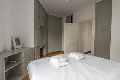 a bedroom with a white bed with towels on it at Deco Marble Apt with Acropolis view in Athens