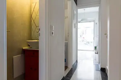 a bathroom with a sink and a red cabinet at Deco Marble Apt with Acropolis view in Athens