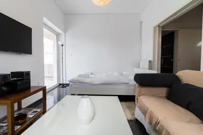 a living room with a couch and a bed at An adorable Apartment in Athens in Athens