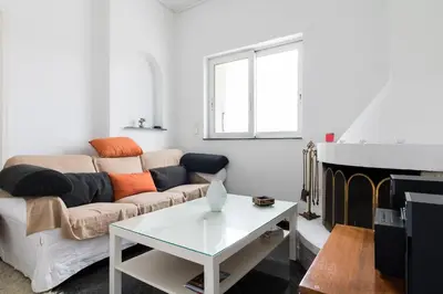 a living room with a couch and a table at An adorable Apartment in Athens in Athens