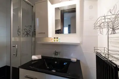a bathroom with a black sink and a mirror at An adorable Apartment in Athens in Athens