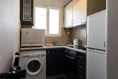 a kitchen with a washing machine and a refrigerator at An adorable Apartment in Athens in Athens