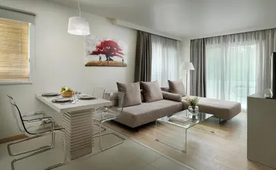 a living room with a couch and a table at Blazer Suites Hotel in Athens
