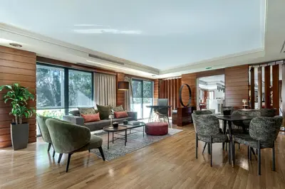 a living room with a couch and a table and chairs at Blazer Suites Hotel in Athens