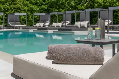 a swimming pool with a towel sitting on a table at Blazer Suites Hotel in Athens