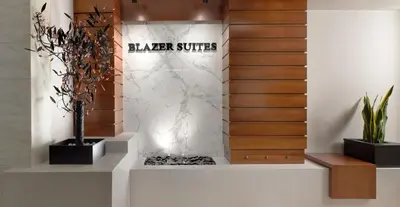 a lobby with a wall with a sign that reads player suites at Blazer Suites Hotel in Athens
