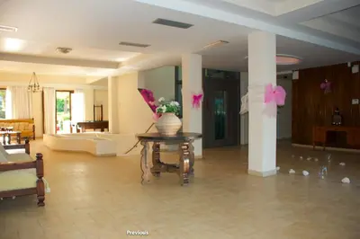 a living room with a vase of flowers on a table at Galini Hotel in Agia Marina Aegina