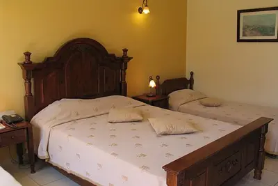 a bedroom with two beds and two night stands at Galini Hotel in Agia Marina Aegina