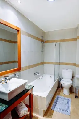 a bathroom with a tub and a sink and a toilet at Athens Mirabello in Athens