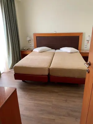 a bedroom with a large bed with two pillows at Athens Mirabello in Athens