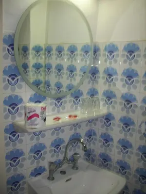 a bathroom with a sink and a mirror at Claridge Hotel in Athens