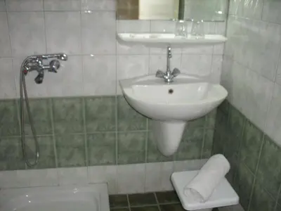 a bathroom with a sink and a shower and a toilet at Claridge Hotel in Athens