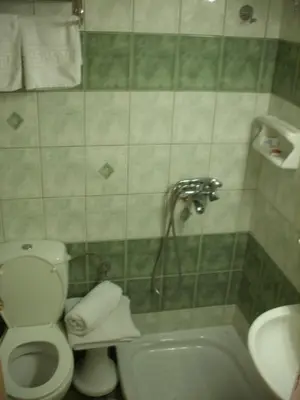 a bathroom with a toilet and a sink and a shower at Claridge Hotel in Athens