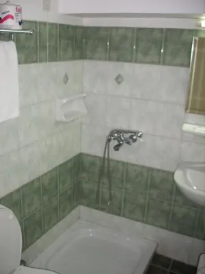 a bathroom with a tub and a sink and a toilet at Claridge Hotel in Athens
