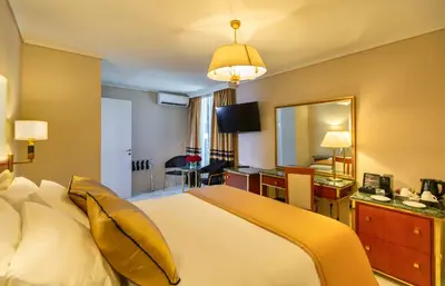 a hotel room with a bed and a mirror at Ilisia Hotel Athens in Athens