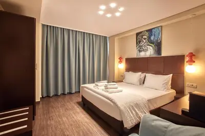 a hotel room with a bed and a couch at Athens Way Pop Art Hotel in Athens