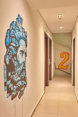 a mural of a man on the wall in a hallway at Athens Way Pop Art Hotel in Athens