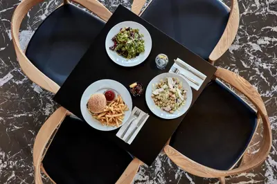 a table with two plates of food on a table at Candia Hotel in Athens