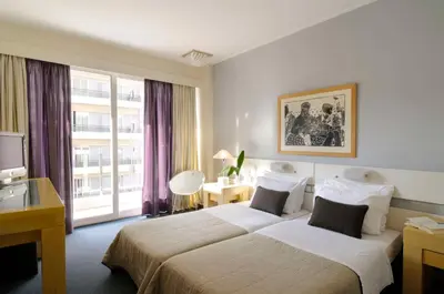 a hotel room with a large bed and a window at Dorian Inn - Sure Hotel Collection by Best Western in Athens