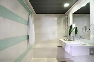 a white bathroom with a tub and a sink at Dorian Inn - Sure Hotel Collection by Best Western in Athens