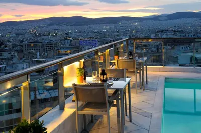 a balcony with tables and a view of a city at Dorian Inn - Sure Hotel Collection by Best Western in Athens