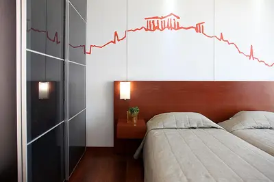 two beds in a bedroom with a chart on the wall at Dorian Inn - Sure Hotel Collection by Best Western in Athens