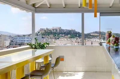 a room with a view of a city with a table and chairs at Dorian Inn - Sure Hotel Collection by Best Western in Athens