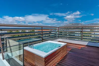 a hot tub on the balcony of a building at Glyfada Riviera Hotel in Athens