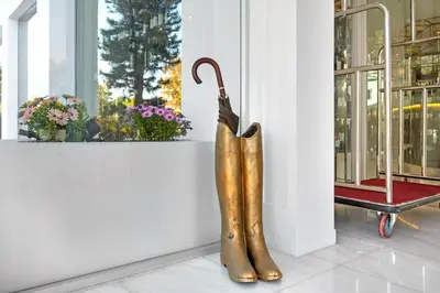 a statue of a pair of boots next to a window at Glyfada Riviera Hotel in Athens