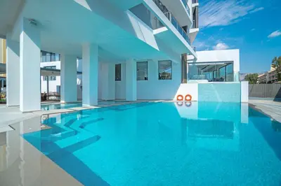 a swimming pool in the middle of a building at Glyfada Riviera Hotel in Athens