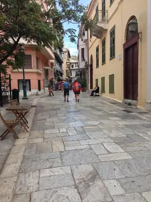 a group of people walking down a street at Beautiful Apartment at Plaka in Athens
