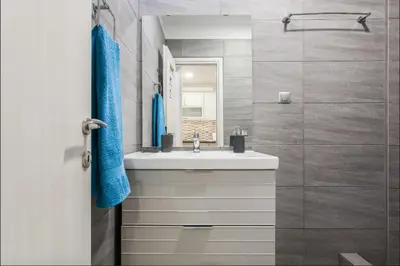 a bathroom with a white sink and a shower at Beautiful Apartment at Plaka in Athens