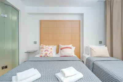 a bedroom with a bed with two pillows on it at Chic Hotel in Athens