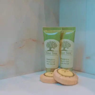 two bottles of olive tree products sitting on a counter at Chic Hotel in Athens