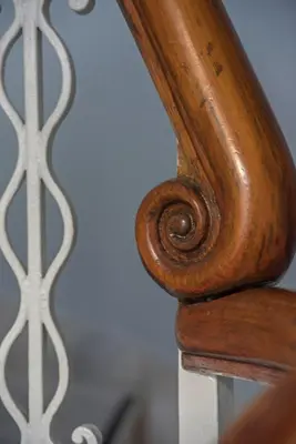 a close up of a wooden rail on a bed at Kimon Hotel Athens in Athens
