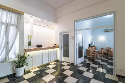 a living room with a checkered floor at Ares Athens Hotel in Athens