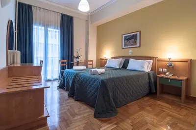 a hotel room with a bed and a television at Ares Athens Hotel in Athens
